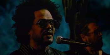 Movie still from “Savage x Fenty Show Vol. 4” (2022), directed by Alex Rudzinski – A person with a microphone; Close Up shot, Low angle