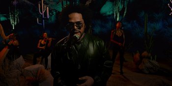 Movie still from “Savage x Fenty Show Vol. 4” (2022), directed by Alex Rudzinski – A man in a leather jacket singing into a microphone; Medium shot, Low angle