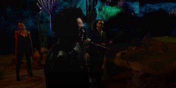 Movie still from “Savage x Fenty Show Vol. 4” (2022), directed by Alex Rudzinski – Two men are singing into a microphone in front of some cactus; Medium shot, Low angle