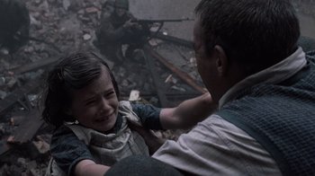 Movie still from “Saving Private Ryan” (1998), directed by Steven Spielberg – A young girl is crying while a man is combing her hair; Medium shot, High angle