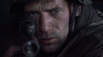 Movie still from “Saving Private Ryan” (1998), directed by Steven Spielberg – A person with a rifle; Close Up shot, Over the shoulder angle