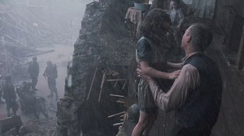 Movie still from “Saving Private Ryan” (1998), directed by Steven Spielberg – A group of people standing on top of a cliff; Wide shot, High angle