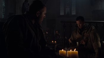Movie still from “Saving Private Ryan” (1998), directed by Steven Spielberg – Two people sitting at a table with candles; Medium shot, Low angle