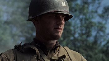 Movie still from “Saving Private Ryan” (1998), directed by Steven Spielberg – A man in a military uniform wearing a helmet; Close Up shot, Low angle