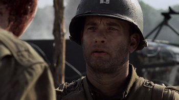 Movie still from “Saving Private Ryan” (1998), directed by Steven Spielberg – A man wearing a helmet is looking at the camera; Close Up shot, Over the shoulder angle