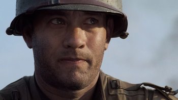 Movie still from “Saving Private Ryan” (1998), directed by Steven Spielberg – A person wearing a helmet; Close Up shot, Low angle