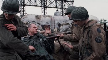 Movie still from “Saving Private Ryan” (1998), directed by Steven Spielberg – A group of men dressed in military uniforms; Medium shot, Over the shoulder angle