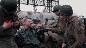 Movie still from “Saving Private Ryan” (1998), directed by Steven Spielberg – A group of men dressed in military uniforms; Medium shot, Over the shoulder angle