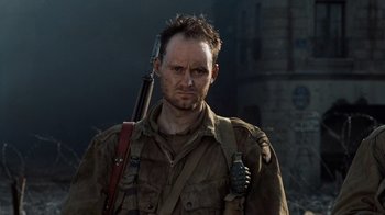 Movie still from “Saving Private Ryan” (1998), directed by Steven Spielberg – A man with a gun in his hand; Close Up shot, Low angle