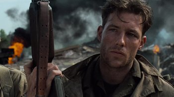 Movie still from “Saving Private Ryan” (1998), directed by Steven Spielberg – A person holding a gun; Close Up shot, Low angle