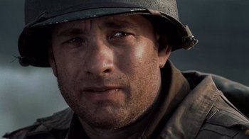 Movie still from “Saving Private Ryan” (1998), directed by Steven Spielberg – A person wearing a helmet; Close Up shot, Over the shoulder angle
