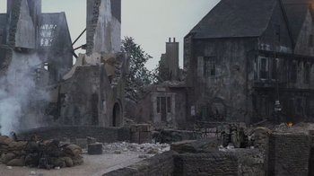 Movie still from “Saving Private Ryan” (1998), directed by Steven Spielberg – An image of an old building in the middle of a town; Extreme Wide shot, High angle