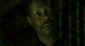 Movie still from “Saw” (2004), directed by James Wan – A person looking at the camera; Close Up shot, Low angle