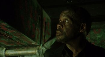 Movie still from “Saw” (2004), directed by James Wan – A person looking up at something; Close Up shot, Low angle
