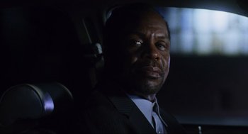 Movie still from “Saw” (2004), directed by James Wan – A man wearing a suit and tie sitting in a car; Close Up shot, Low angle