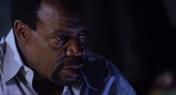 Movie still from “Saw” (2004), directed by James Wan – A person looking at the camera; Close Up shot, Low angle