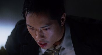 Movie still from “Saw” (2004), directed by James Wan – A person wearing a suit and tie; Close Up shot, Overhead angle