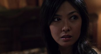 Movie still from “Saw” (2004), directed by James Wan – A person with long black hair; Close Up shot, Over the shoulder angle