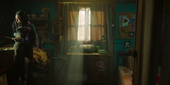 Movie still from “Sayen” (2023), directed by Alexander Witt – The sun shines through the window of a bedroom; Wide shot, High angle