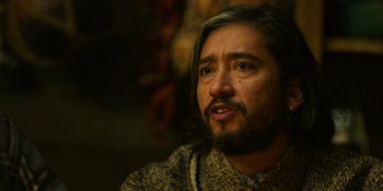 Movie still from “Sayen” (2023), directed by Alexander Witt – A person with long hair and a beard; Close Up shot, Over the shoulder angle