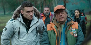 Movie still from “Sayen” (2023), directed by Alexander Witt – A group of men walking down a sidewalk; Medium shot, Low angle