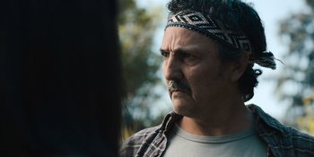Movie still from “Sayen” (2023), directed by Alexander Witt – A person wearing a head band; Close Up shot, Over the shoulder angle