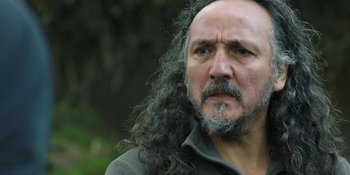 Movie still from “Sayen” (2023), directed by Alexander Witt – A person with long hair and a beard; Close Up shot, Low angle