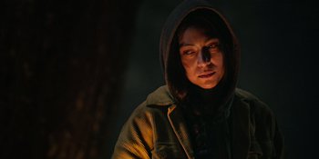 Movie still from “Sayen” (2023), directed by Alexander Witt – A person wearing a hooded jacket in the dark; Close Up shot, Low angle