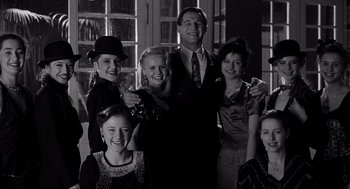 Movie still from “Schindler's List” (1993), directed by Steven Spielberg – A group of people standing next to each other in a room; Medium shot, Low angle