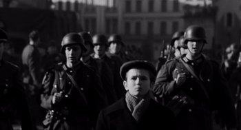 Movie still from “Schindler's List” (1993), directed by Steven Spielberg – Black and white photograph of a group of men in military uniforms; Medium shot, Low angle