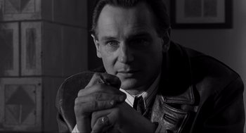 Movie still from “Schindler's List” (1993), directed by Steven Spielberg – Black and white photograph of a man in a leather jacket; Close Up shot, Over the shoulder angle