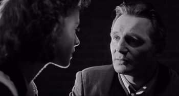 Movie still from “Schindler's List” (1993), directed by Steven Spielberg – An older man and a young woman looking at each other; Close Up shot, Low angle
