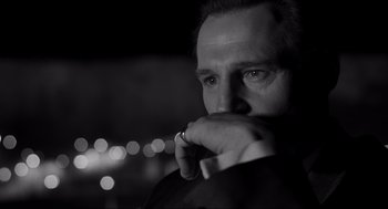 Movie still from “Schindler's List” (1993), directed by Steven Spielberg – Black and white photograph of a man in a suit; Close Up shot, Over the shoulder angle