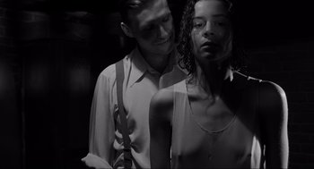 Movie still from “Schindler's List” (1993), directed by Steven Spielberg – A man and a woman standing next to each other; Close Up shot, Low angle