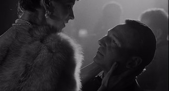 Movie still from “Schindler's List” (1993), directed by Steven Spielberg – A man and a woman are looking into each others eyes; Close Up shot, Low angle