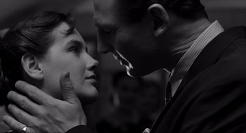 Movie still from “Schindler's List” (1993), directed by Steven Spielberg – A black and white photo of a man and a woman; Close Up shot, Over the shoulder angle
