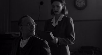 Movie still from “Schindler's List” (1993), directed by Steven Spielberg – An old man and a woman in a room; Medium shot, Low angle