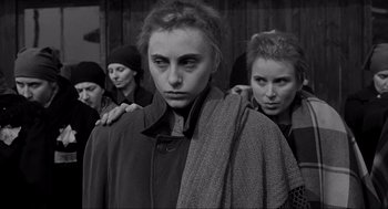 Movie still from “Schindler's List” (1993), directed by Steven Spielberg – A group of women standing next to each other; Medium shot, Over the shoulder angle
