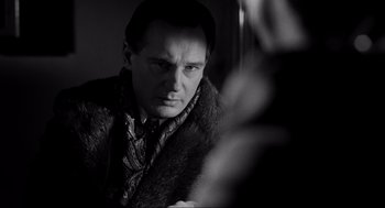 Movie still from “Schindler's List” (1993), directed by Steven Spielberg – A black and white photo of a man in a fur coat; Close Up shot, Over the shoulder angle