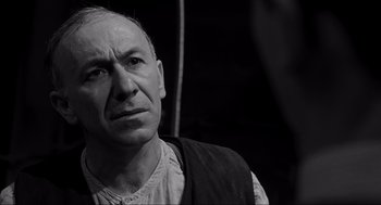 Movie still from “Schindler's List” (1993), directed by Steven Spielberg – An older man is looking at the camera; Close Up shot, Over the shoulder angle