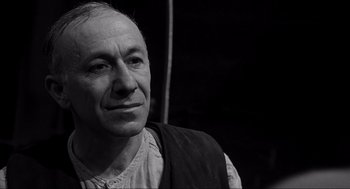 Movie still from “Schindler's List” (1993), directed by Steven Spielberg – An older man is looking into the distance; Close Up shot, Low angle