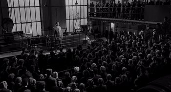 Movie still from “Schindler's List” (1993), directed by Steven Spielberg – An old photo of a crowd of people in a building; Extreme Wide shot, High angle