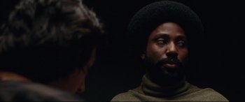Movie still from “BlacKkKlansman” (2018), directed by Spike Lee – A man with a beard is talking to another man; Close Up shot, Over the shoulder angle