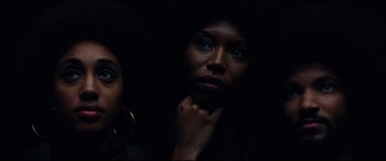 Movie still from “BlacKkKlansman” (2018), directed by Spike Lee – A woman with her hand under her chin; Close Up shot, Low angle
