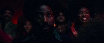 Movie still from “BlacKkKlansman” (2018), directed by Spike Lee – A man with a beard and red eyes looking at the camera; Close Up shot, Low angle