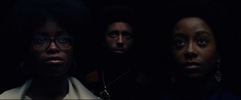 Movie still from “BlacKkKlansman” (2018), directed by Spike Lee – A man in a dark room looking up at the sky; Close Up shot, Low angle