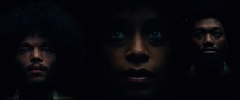 Movie still from “BlacKkKlansman” (2018), directed by Spike Lee – A person's face in the dark; Extreme Close Up shot, Low angle