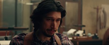 Movie still from “BlacKkKlansman” (2018), directed by Spike Lee – A person with long black hair; Close Up shot, Over the shoulder angle