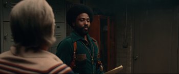 Movie still from “BlacKkKlansman” (2018), directed by Spike Lee – A man in a green shirt is looking at another man in a green shirt; Medium shot, Over the shoulder angle