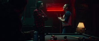 Movie still from “BlacKkKlansman” (2018), directed by Spike Lee – Two men standing next to each other in front of a pool table; Medium shot, Over the shoulder angle